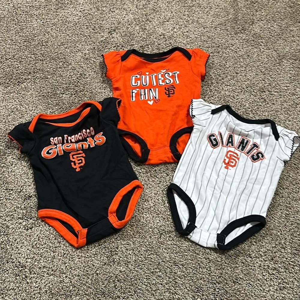 Toddler girls San Francisco Giants short sleeve onesies.